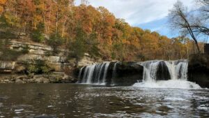 View of water rushing at Cataract Falls with autumn trees in the background near Gatlinburg, Tennessee, USA